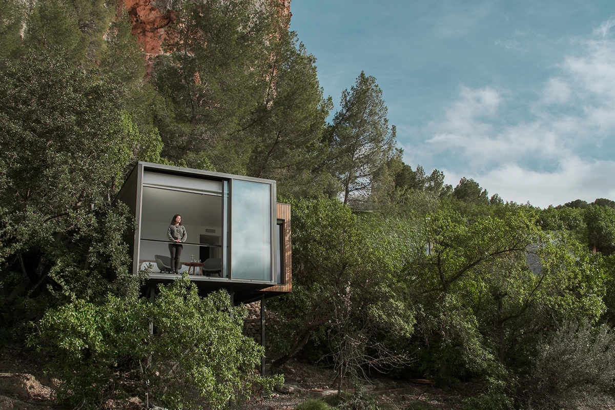 Mujer en la terraza de una suite integrada en la naturaleza en VIVOOD.